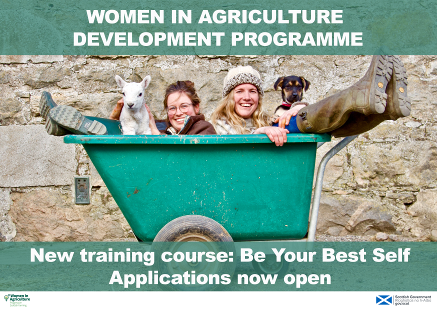 Photo showing two women in agriculture in a wheelbarrow with a lamb and a puppy.
